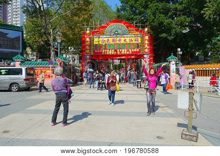 HONG KONG, CHINA - JANUARY 22, 2017: Unidentified people walking through the enter of Wong Tai Sin Buddhist Temple to pray, in Hong Kong, China.