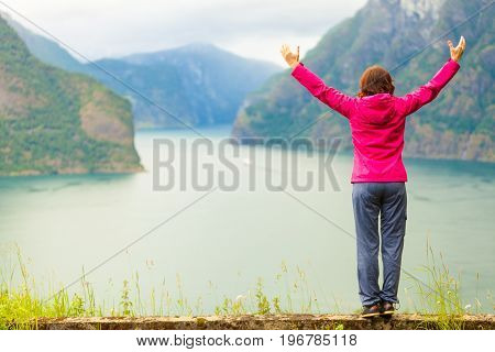 Woman With Raised Hands In Norwegian Mountains Fjords