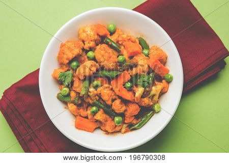 indian spicy food Gobi matar Masala or cauliflower curry with green peas or phool gobi fry, selective focus