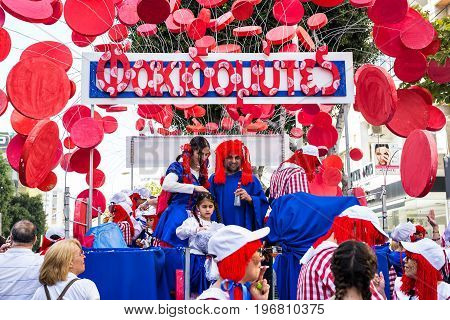 LIMASSOL, CYPRUS - FEBRUARY 26: Carnivalists in a silver cylinder hats joyfully follow the Limassol Municipality Band during the annual Carnival Parade, February 26, 2017 in Limassol.