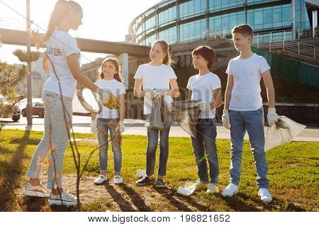 Proud of yourselves. Warm-hearted coach praising her pupils while feeling happiness and congratulating them after finishing hard work