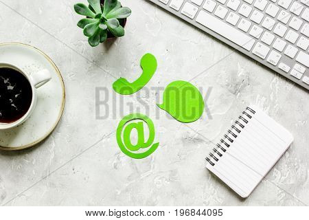 customer support company office with contact us sign and coffee on tone desk background top view mockup