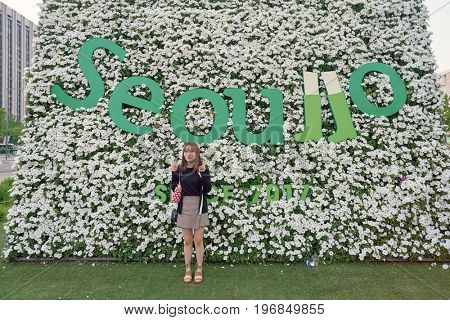 SEOUL, SOUTH KOREA -  MAY 21, 2017: woman posing for taking photo at Seoul 7017 Skypark sign. The Seoullo 7017 Skypark, is an elevated linear park in central Seoul  which opened on May 20, 2017.