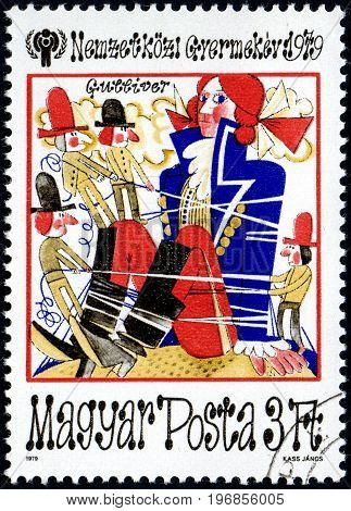 UKRAINE - CIRCA 2017: A postage stamp printed in Hungary shows Fairy Tale Scenes from Gulliver's travels from series International Year of the Child circa 1979