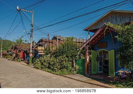Maringá, Brazil - January 19, 2015. View of street, colorful houses and blue sky in Maringá, a village in the mountains with perfect weather. Located in the Rio de Janeiro State, southwestern Brazil