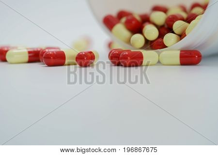Antibiotic capsule pills with bottle on white background