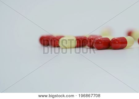 Two tone antibiotic capsule pills on white background