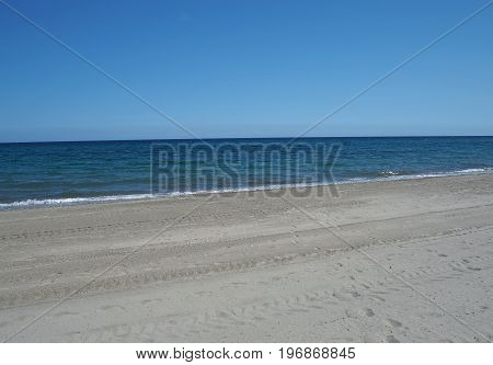 Clean Empty Sand Beach With Blue Sky And Calm Sea