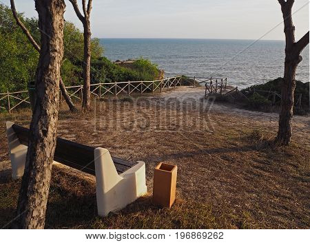 empty bench on a beautiful sea wiew in golden evening light