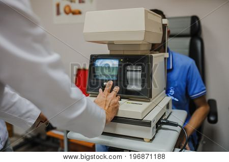 Close Up Of Eye Doctor/optometrist/ophthalmologist Examinating A Young Patient