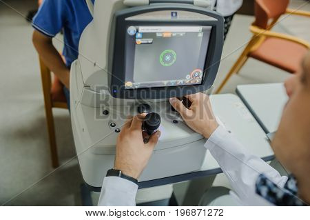 Close Up Of Young Beautiful Doctor/eye Specialist/optometrist In An Ophthalmologic Clinic Dooing A P