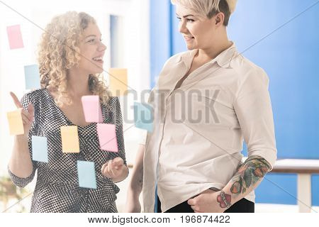 Two blond fimale coworkers brainstoriming at office