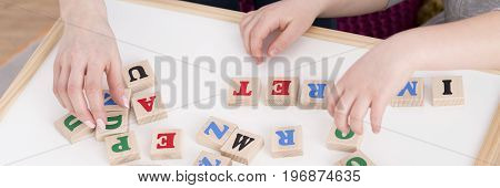 Close-up of speech therapist during reading classes with student