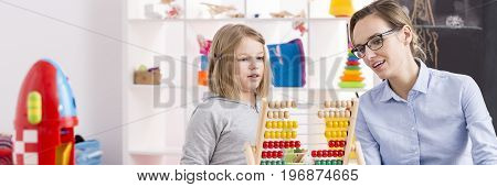 Young girl on extra math lessons with her young teacher