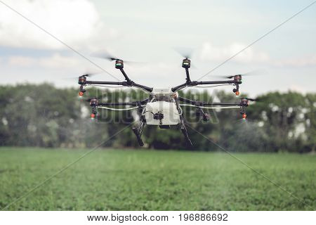 Agriculture drone fly to sprayed fertilizer on the rice fields. Industrial agriculture and smart farming