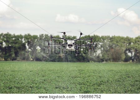 Agriculture drone fly to sprayed fertilizer on the rice fields. Industrial agriculture and smart farming