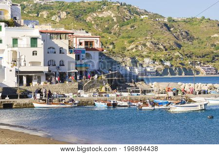 Ischia, Italy - April, 2017: tourist harbor with typical Mediterranean boats in the Sant'angelo on Ischia Island, tourist destination in the Gulf of Naples, Italy