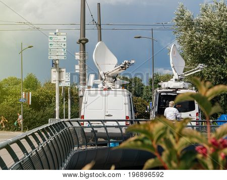 STRASBOURG FRANCE - JUN 30 2017: RTL N:TV TV Media Television Trucks with multiple Satellite parabolic antennas and fiber optic cables preparing to report live the official European Ceremony of Honour for Dr. Helmut Kohl at European Parliament