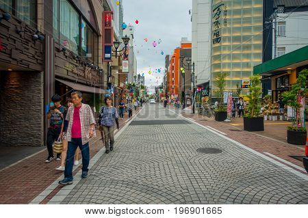 HAKONE, JAPAN - JULY 02, 2017: Unidentified people walking at street. It also provides bus stop for Hakone Tozan Bus back to Hakone-Yumoto and Odawara.