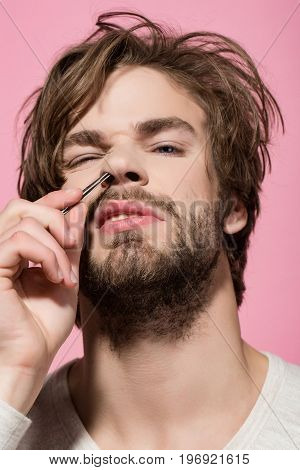 Man Twitch Nose Hair With Tweezers