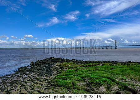 Expanse of the Severn Bridge stretching over the River on a bright early summer day.