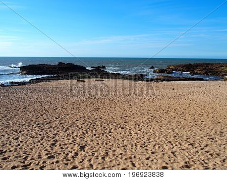 Abandoned rocky beach landscape in town of OUALIDIA in MOROCCO with clear blue sky in 2016 warm and sunny winter day, AFRICA on February