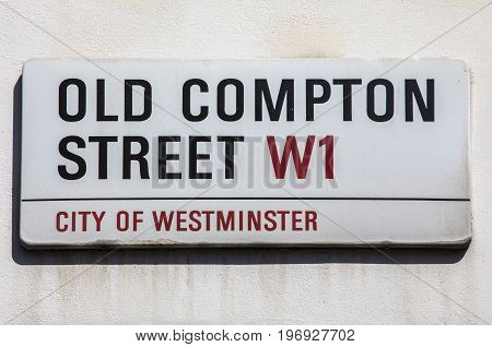 A street sign for Old Compton Street located in the Soho area of London UK.