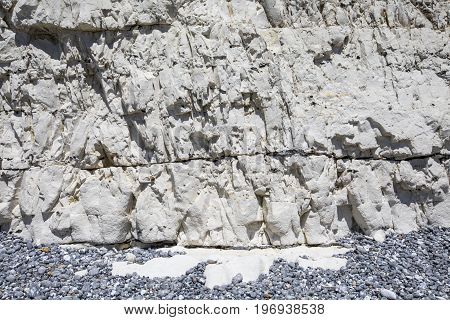 A close-up of the layers of Chalk in the white cliffs along the coastline in East Sussex UK.