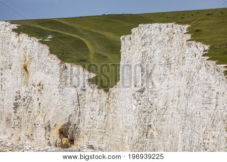 A close-up view of the Seven Sisters white chalk cliffs in East Sussex UK.