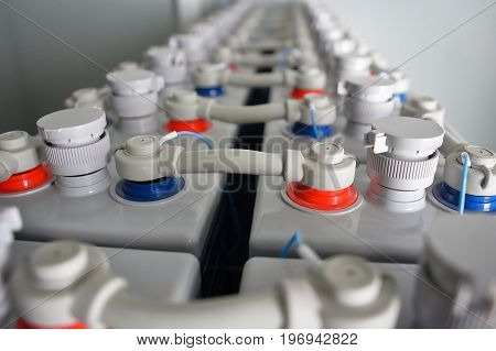 Industrial power electric DC battery accumulators. Direct current and voltage battery.
