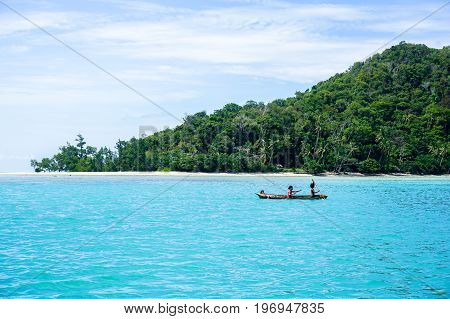 Sea Gypsy kids on unique handmade boats with clear water on at Bodgaya island,Semporna,Sabah,Malaysia.