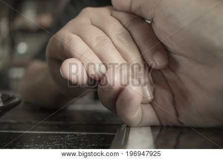 Two Young couple in love hands holding together touch hand for love and takecare vintage tone