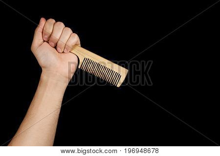 The Fist Wooden Comb Inverted Tooth Diagonal, Isolated On Black Background