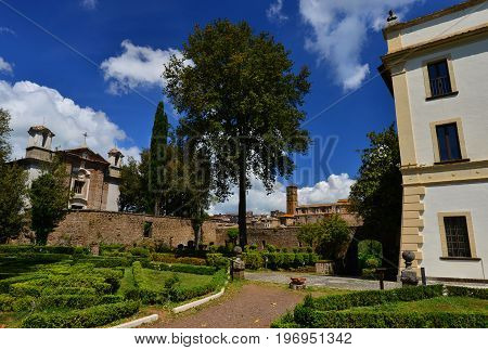 Villa Savorelli public park in the ancient medieval town of Sutri with old church and beautiful clouds