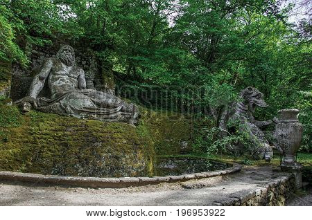 Bomarzo, Italy - May 20, 2013. View of sculpture amidst the vegetation in the Park of Bomarzo. Also known as Park of Monsters, it was created to surprise the visitor with surrealistic works in stone. Lazio region, central Italy