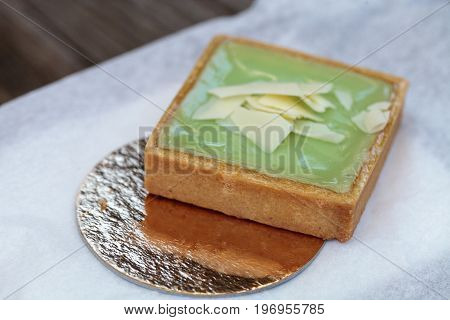 Green Keylime Tart Pastry With A Cookie Crust And White Chocolate Flakes