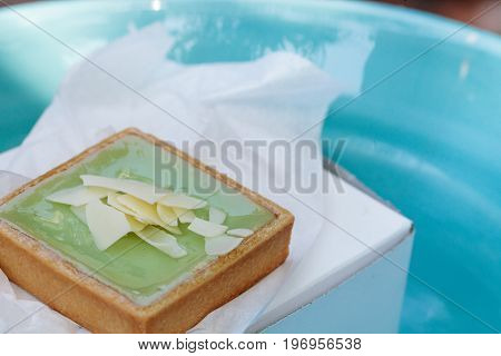 Green Keylime Tart Pastry With A Cookie Crust And White Chocolate Flakes