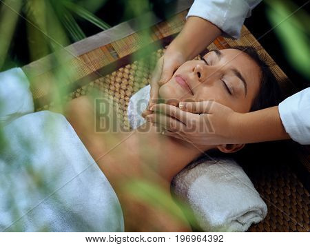 portrait of young beautiful woman relaxing in spa environment