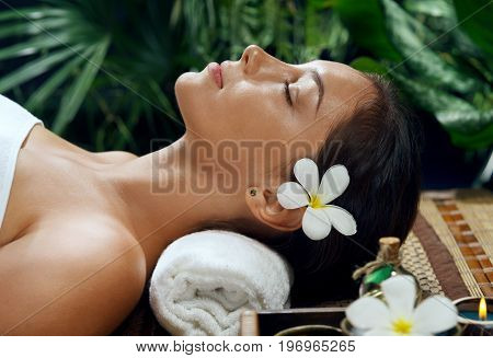 portrait of young beautiful woman relaxing in spa environment