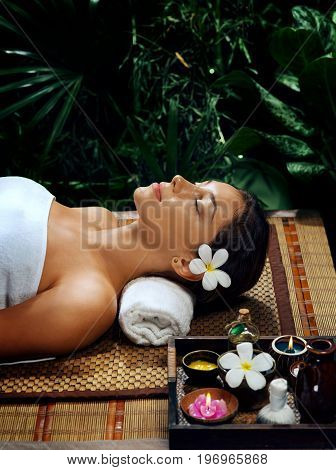 portrait of young beautiful woman relaxing in spa environment