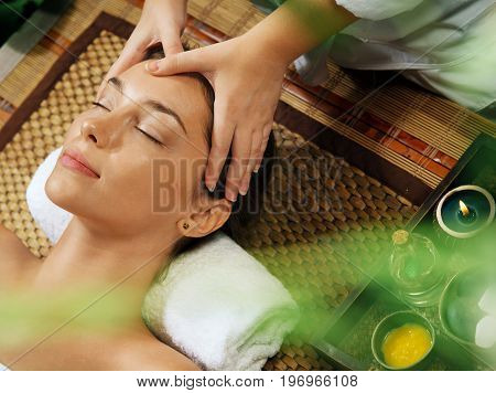 portrait of young beautiful woman relaxing in spa environment