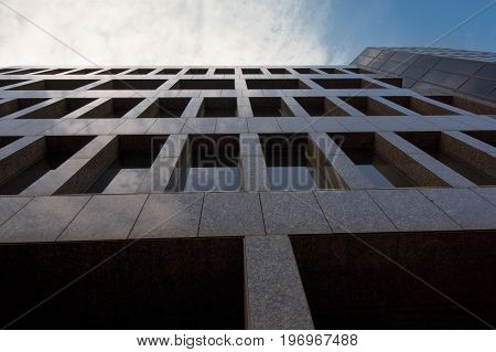 The dark facade of a tall office building in downtown