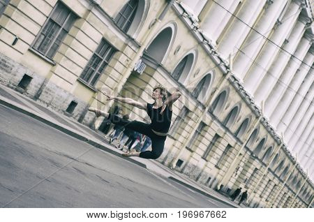 Saint Petersburg Russia - 16 July 2017:  Ballet dancer jumping on Architect Rossi Street near Vaganova Ballet Academy