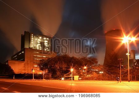 an old coal power plant at night with long time exposure