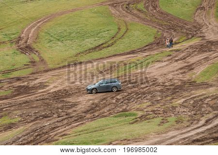 Stepantsminda Gergeti, Georgia - May 23, 2016: Mitsubishi Outlander XL on diirty road. Mitsubishi Pajero Sport is a mid-size crossover produced by the Japanese manufacturer Mitsubishi Motors
