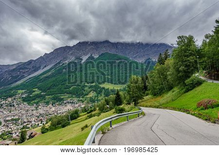 Top view panorama of Bormio city with alps rocks and road