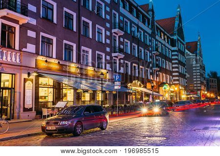 Riga, Latvia - July 1, 2016: Parked Cars On Kalku Street In Evening Or Night Illumination In Old Town