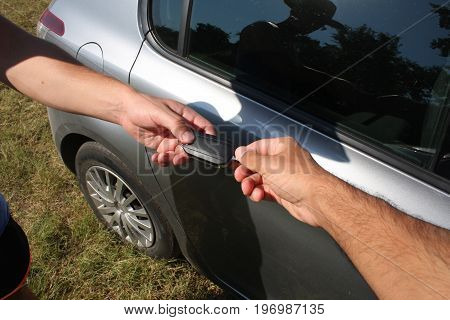 concept of two businessmen when selling a car in a motor show close-up