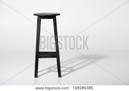 Studio Shot Of Classic Black Tall Wooden Barstool Standing On White