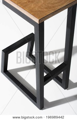 Studio Shot Of Stylish Barstool With Wooden Top And Black Metallic Legs Standing On White